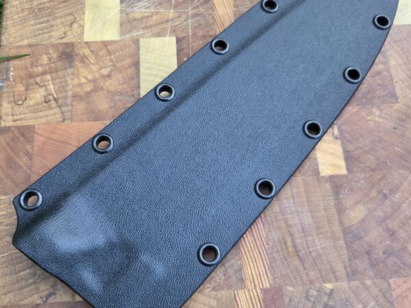 8" chef knife sheath on cutting board. Black kydex with black eyelets